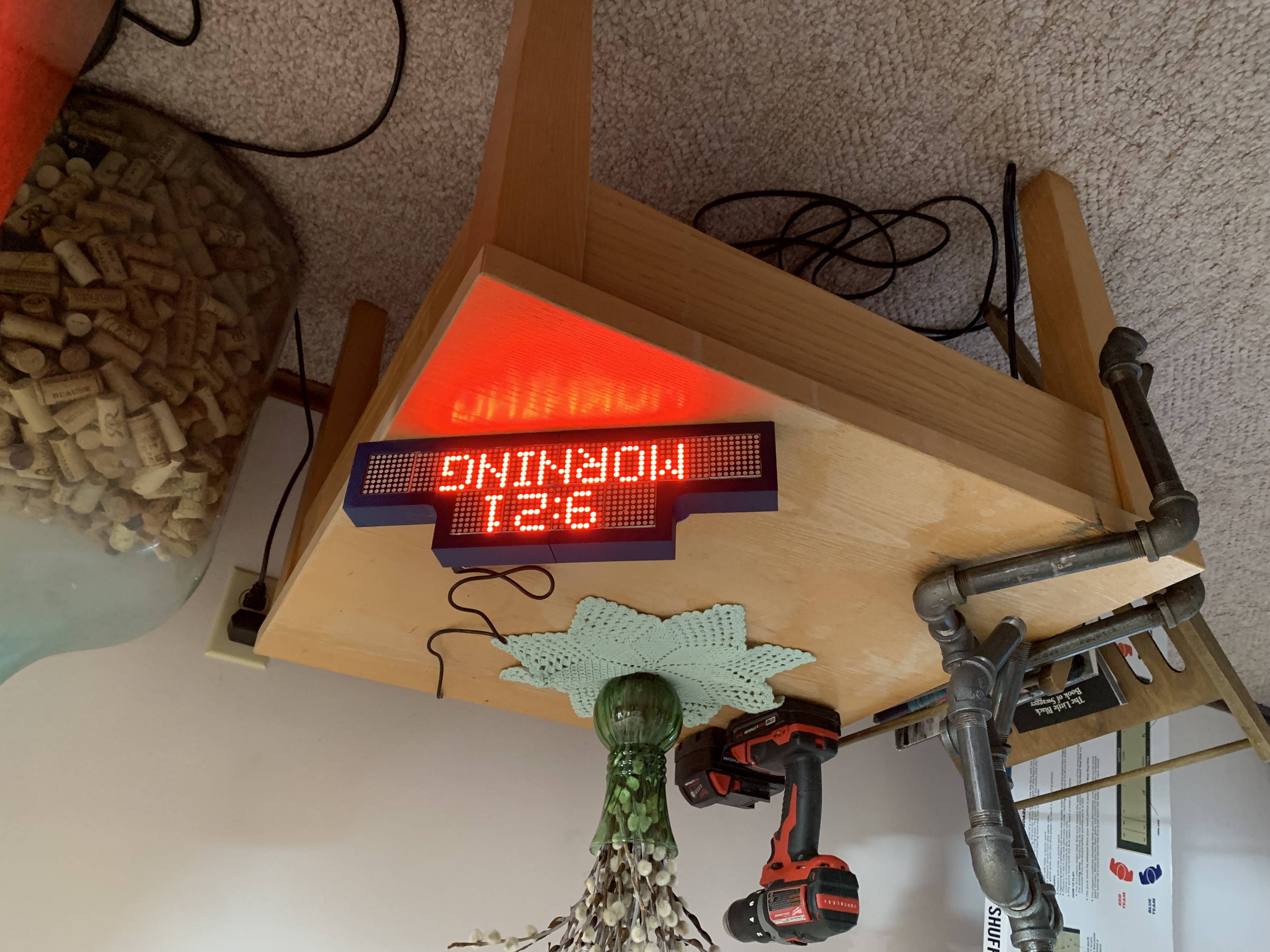 The Dementia Clock on a side table, showing 9:21 above the word MORNING in large red characters